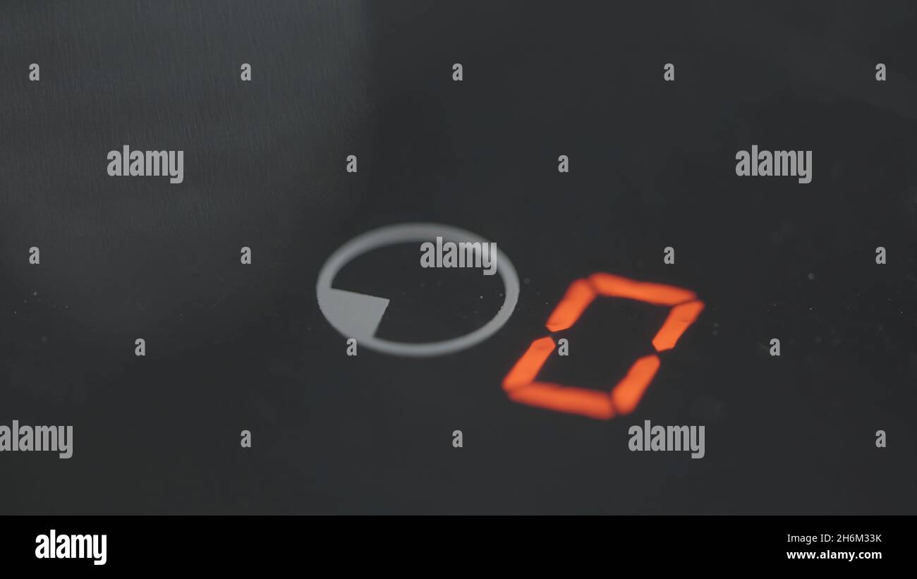 Close-up of pressing timer button on electric stove. Action. Finger ...