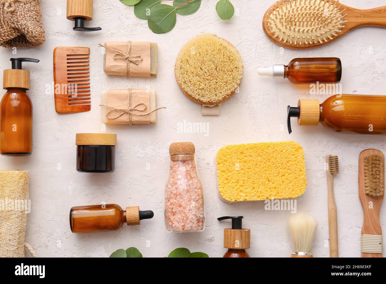 Set of bath supplies with sponges and massage brushes on white