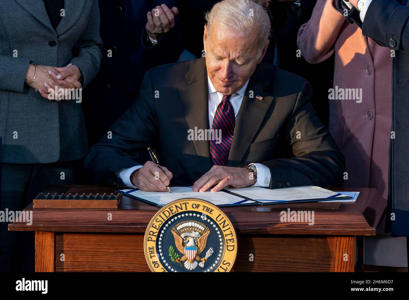 Washington, United States Of America. 15th Nov, 2021. Washington, United States of America. 15 November, 2021. U.S President Joe Biden signs the $1.2 trillion bipartisan infrastructure bill during a ceremony on the South Lawn of the White House November 15, 2021 in Washington, DC Credit: Cameron Smith/White House Photo/Alamy Live News Stock Photo