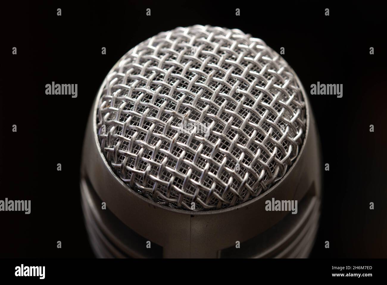 Professional microphone in a music studio on a black background. Record
