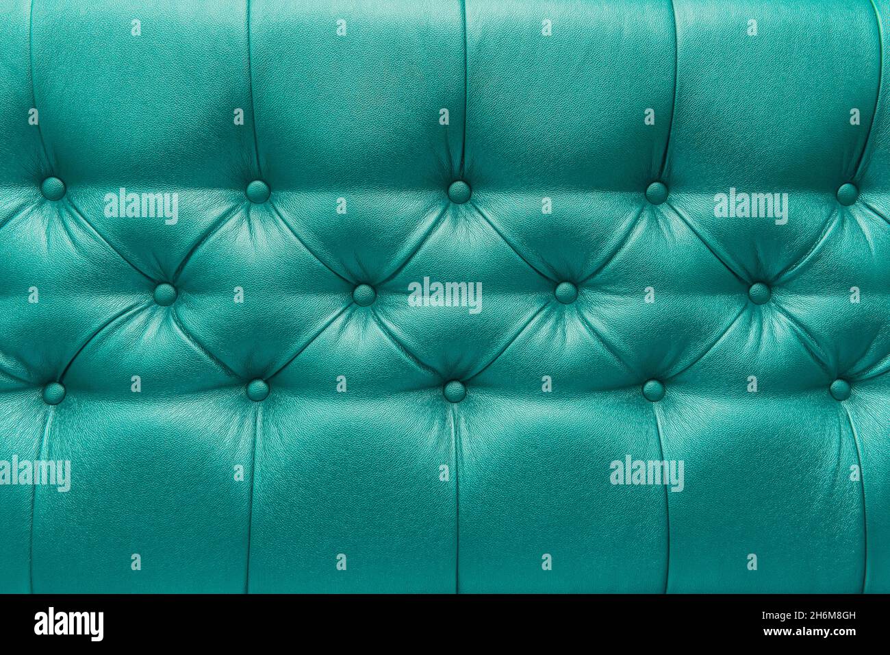 Green or aquamarine leather upholstery sofa with pattern button design furniture style decor texture background. Stock Photo