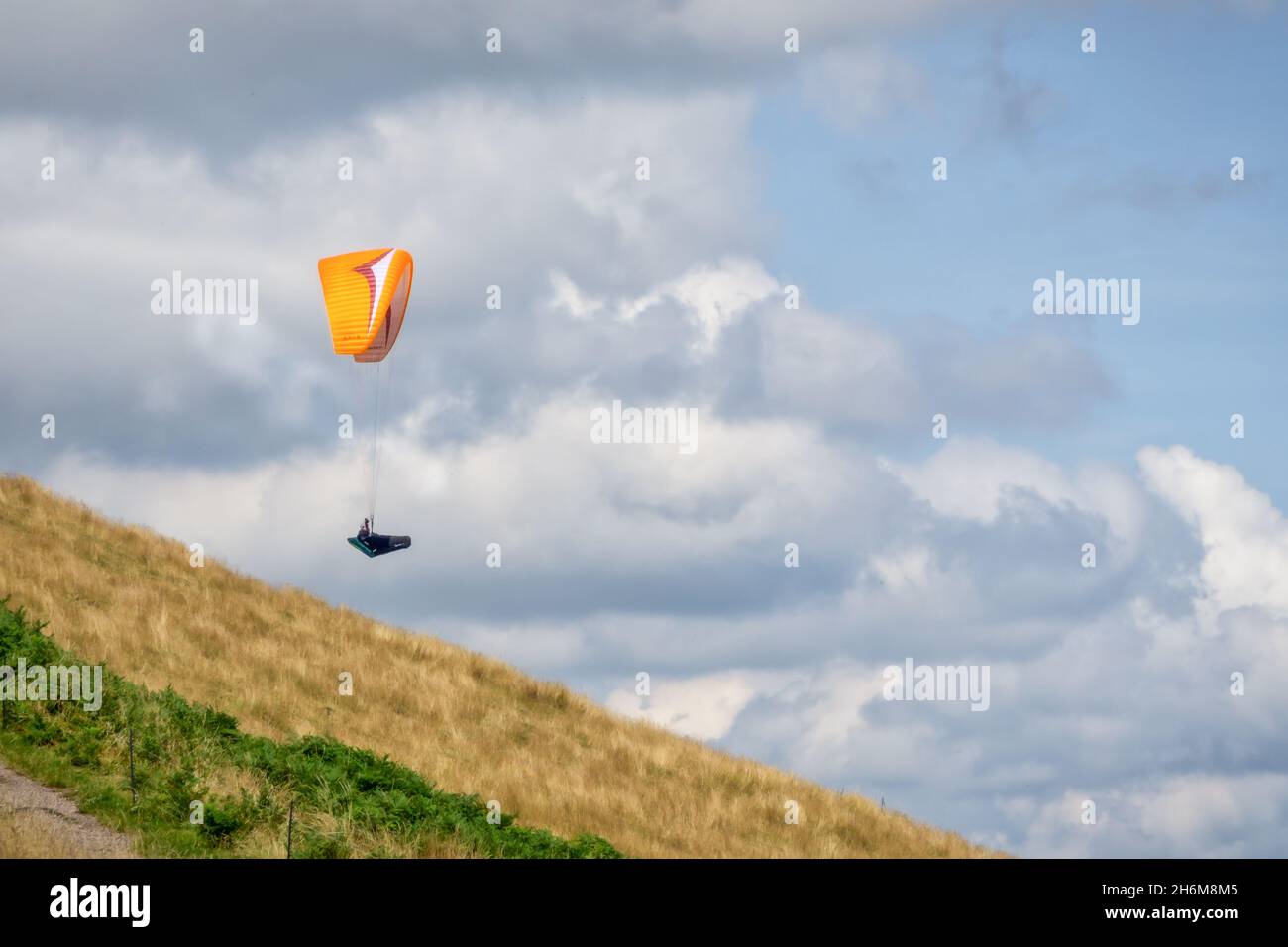 Paraglider launching off the side of a hill in the Malverns Stock Photo