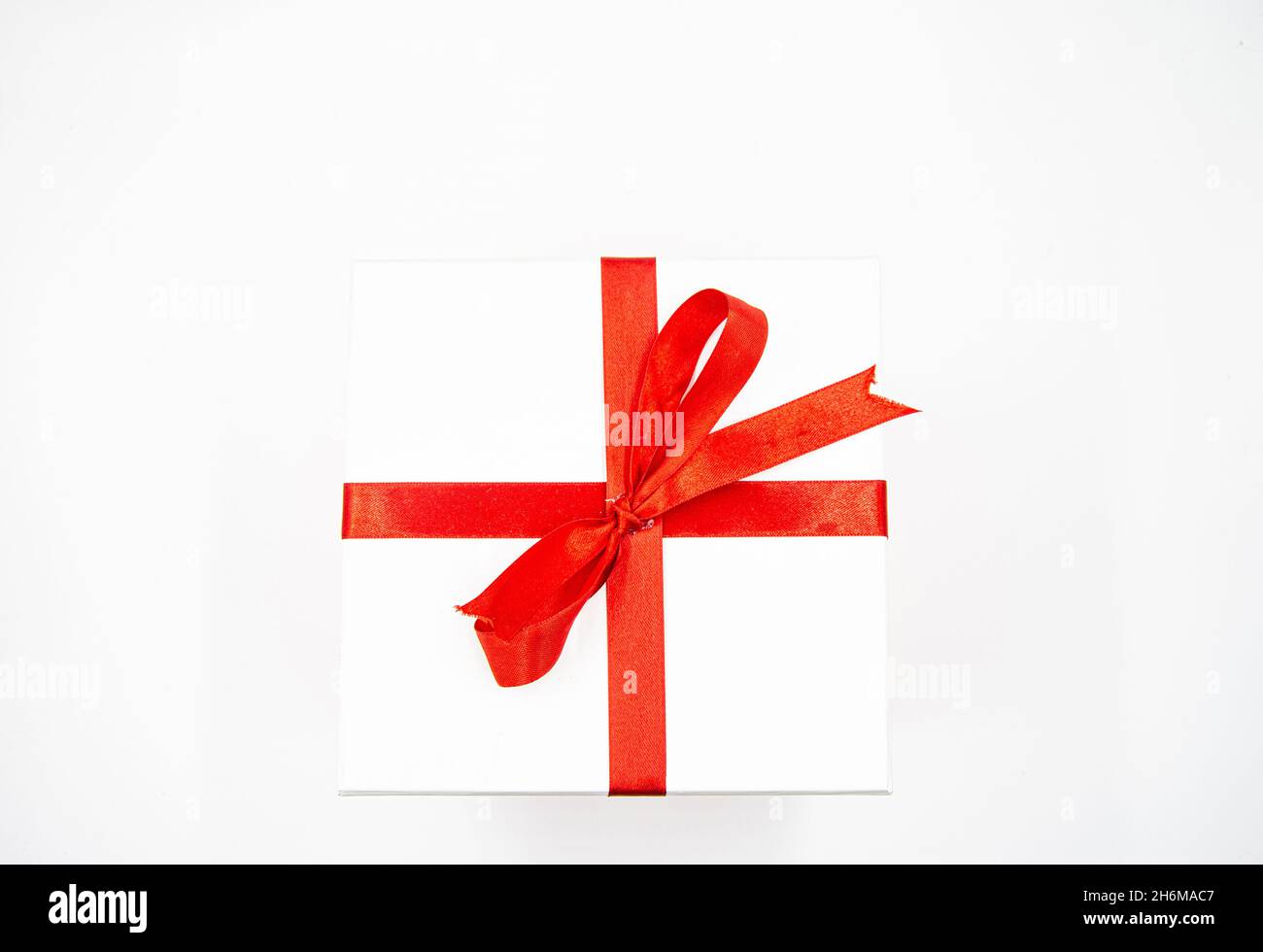 White Gift Box with Red Bow and Ribbons Stock Photo - Alamy