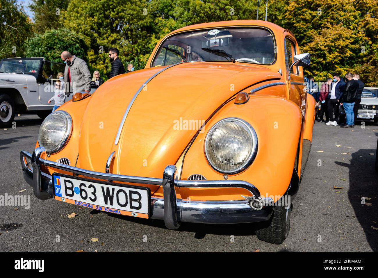 Bucharest, Romania, 24 October 2021: One vivid orange Volkswagen Beetle German vintage car  parked in a street at an event for vintage cars collection Stock Photo