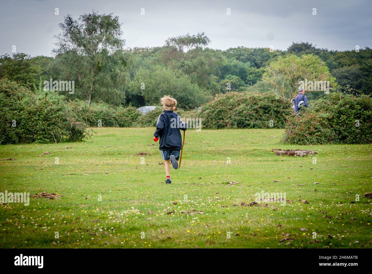 Caucasian 9 year old boy running in the New Forest, Hampshire, UK Stock Photo