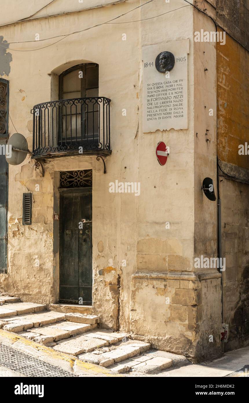 A  plaque with an epitaph to the memory of Fortunato Mizzi was placed at Mizzi’s former house, Valletta, in 1922. Malta, Europe Stock Photo