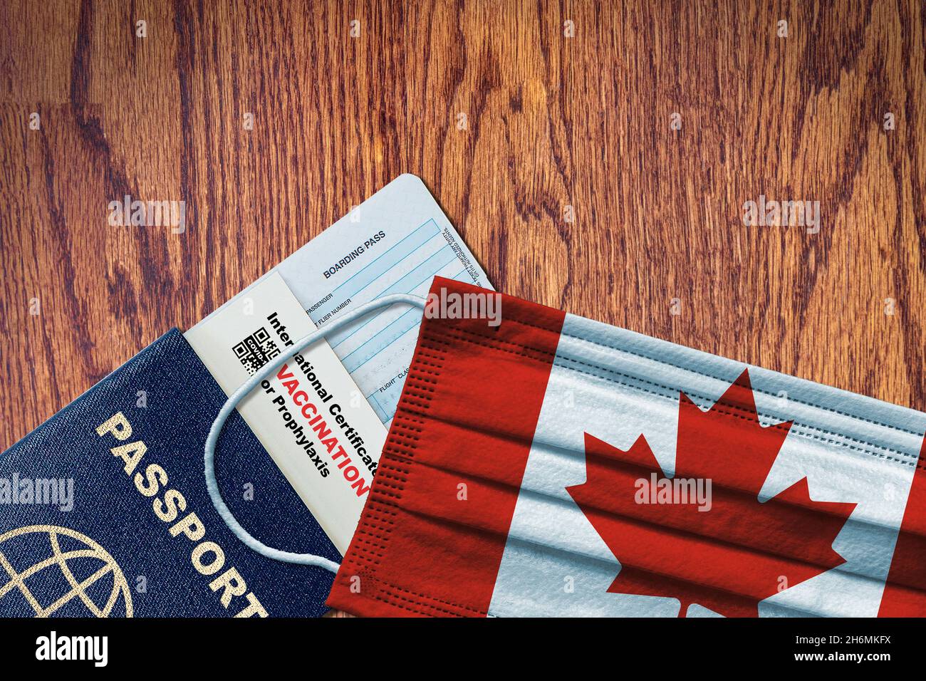 Canada new normal travel with passport, boarding pass, face mask with Canadian flag and certificate of COVID-19 vaccination. Vaccine passport concept Stock Photo