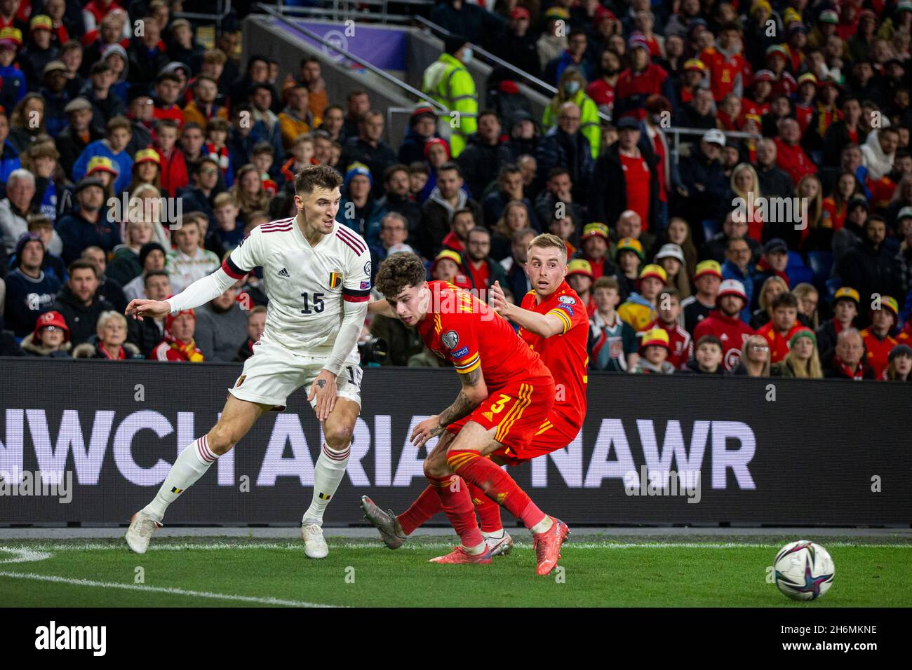 Cardiff, Wales, UK. 16th Nov, 2021. Thomas Meunier of Belgium squeezes the ball past Neco Williams and Joe Morrell of Wales during the World Cup 2022 group qualification match between Wales and Belgium at the Cardiff City Stadium. Credit: Mark Hawkins/Alamy Live News Stock Photo