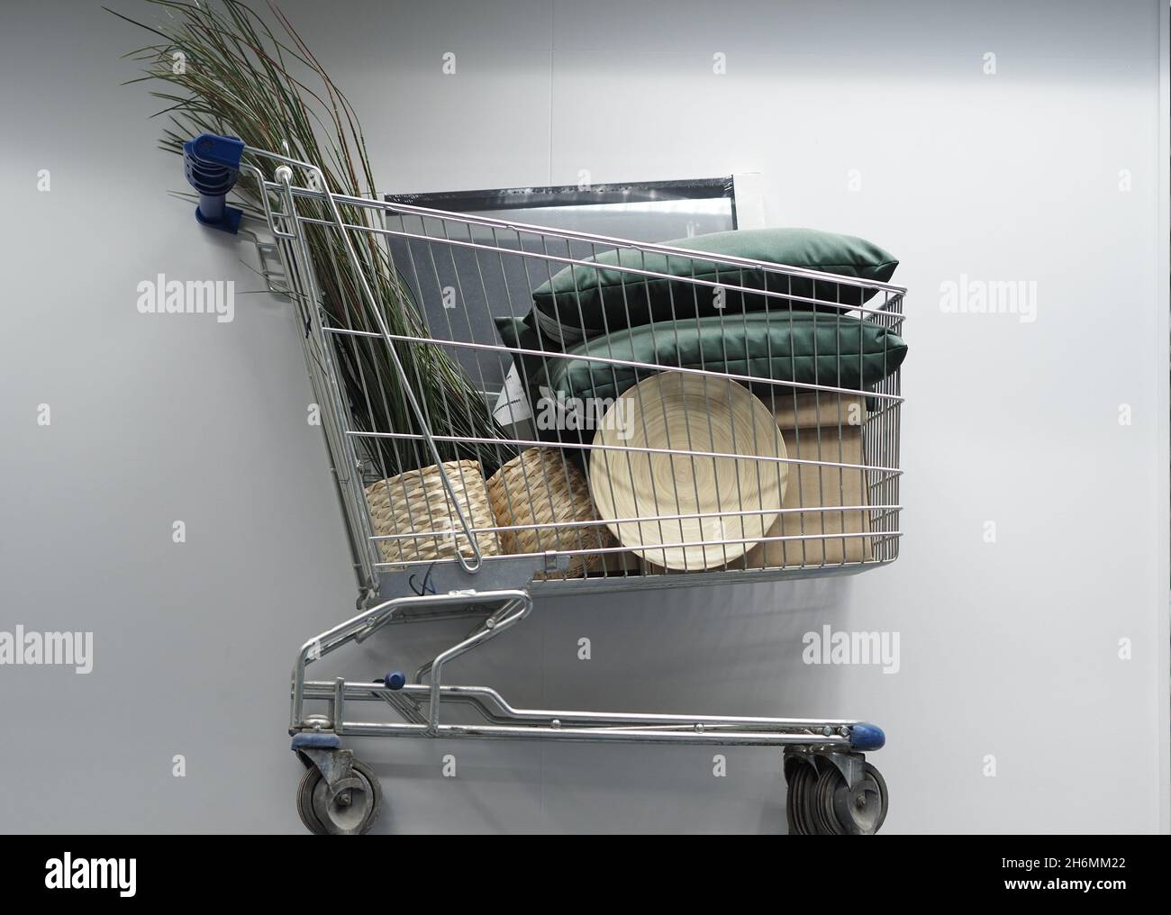 Shopping basket with goods in an industrial and household goods store. High quality photo. Shop, basket, consumer, full basket, purchase, sale, promot Stock Photo