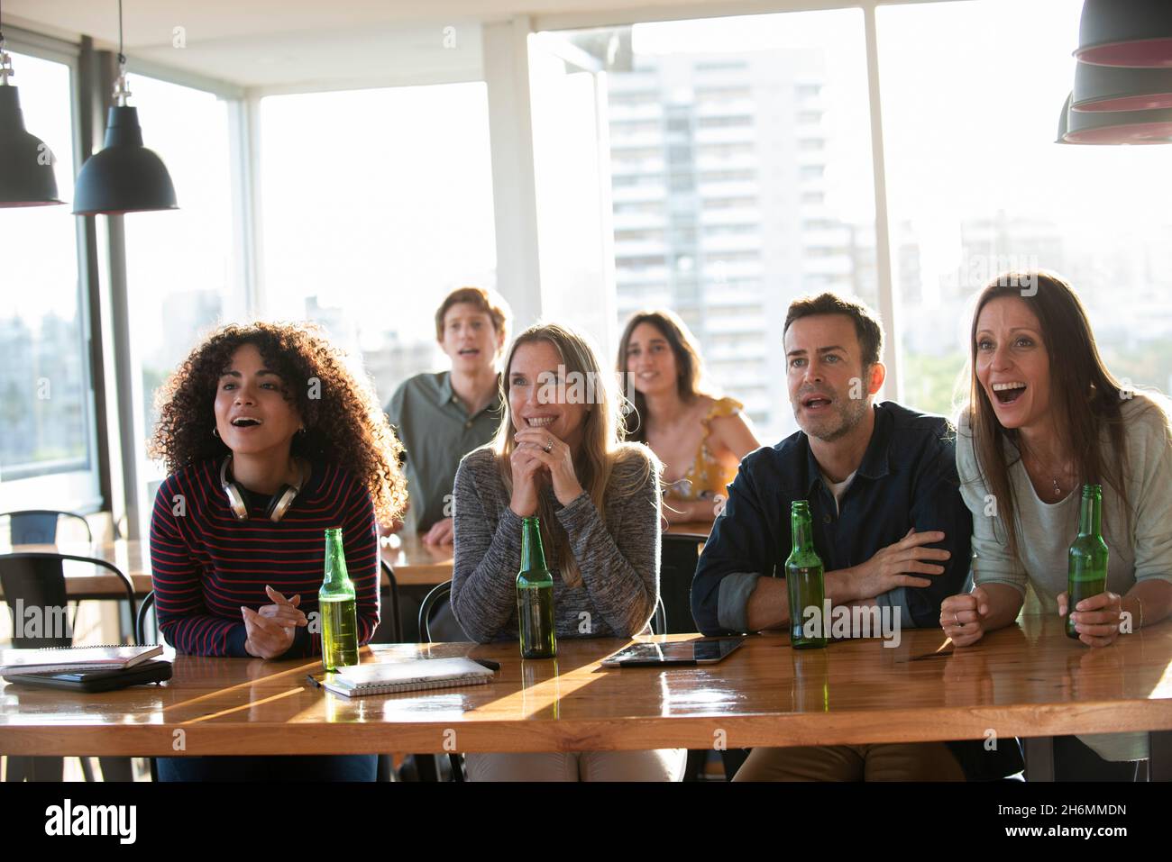 Excited business people sitting in office Stock Photo