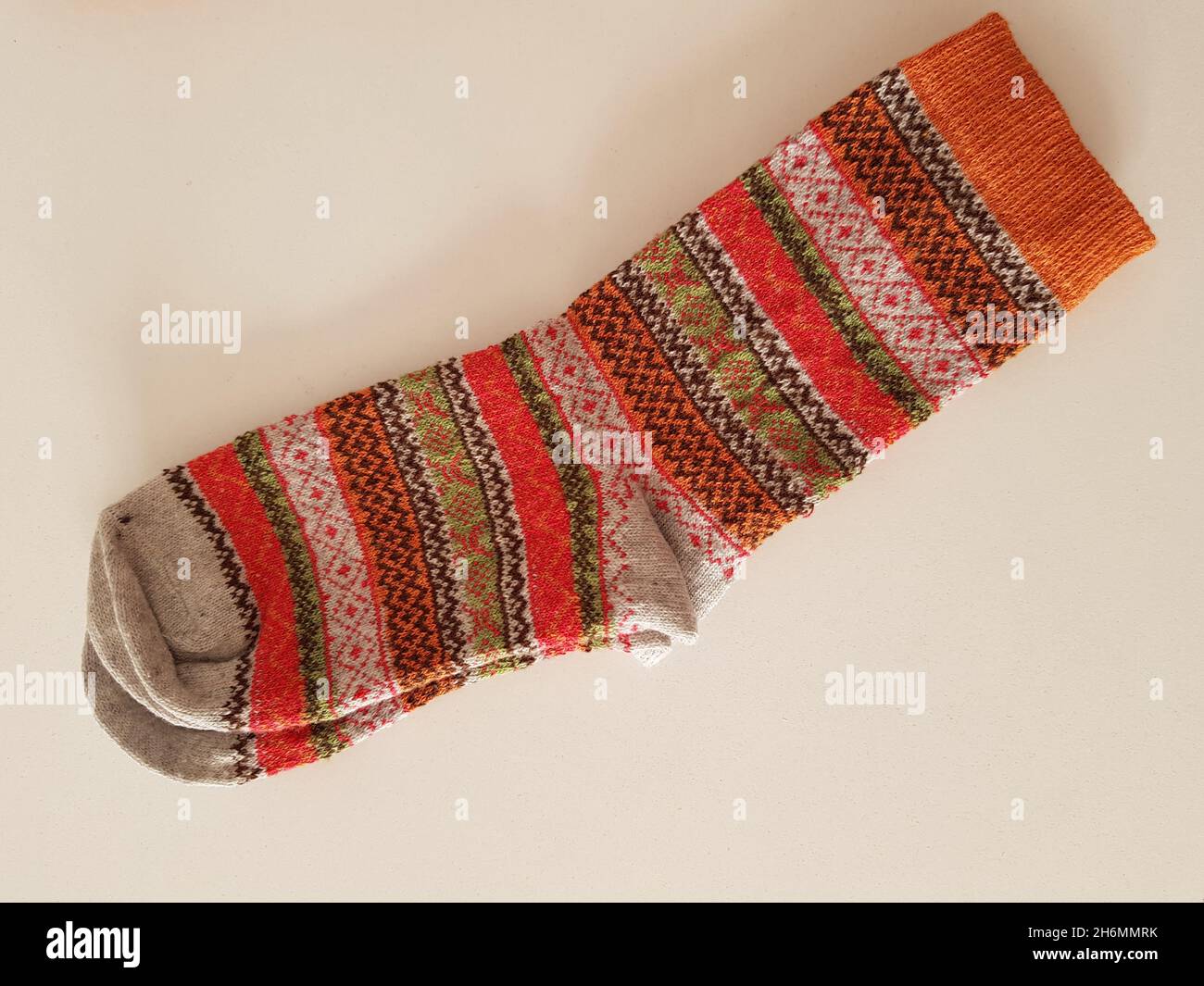 a pair of new hippie warm winter socks with beautiful pattern white table Stock Photo - Alamy
