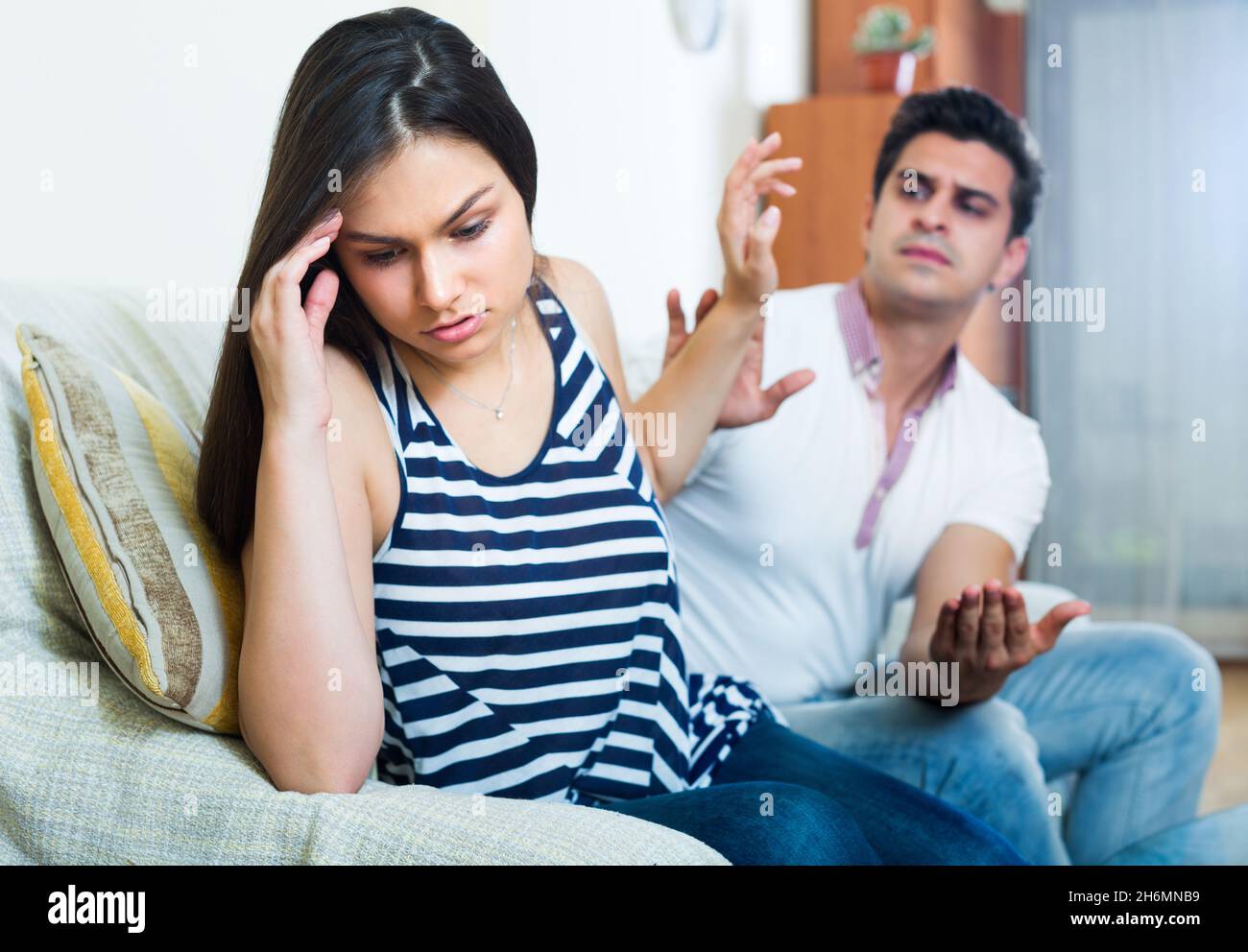 Quarrel between young spouses at home. Stock Photo