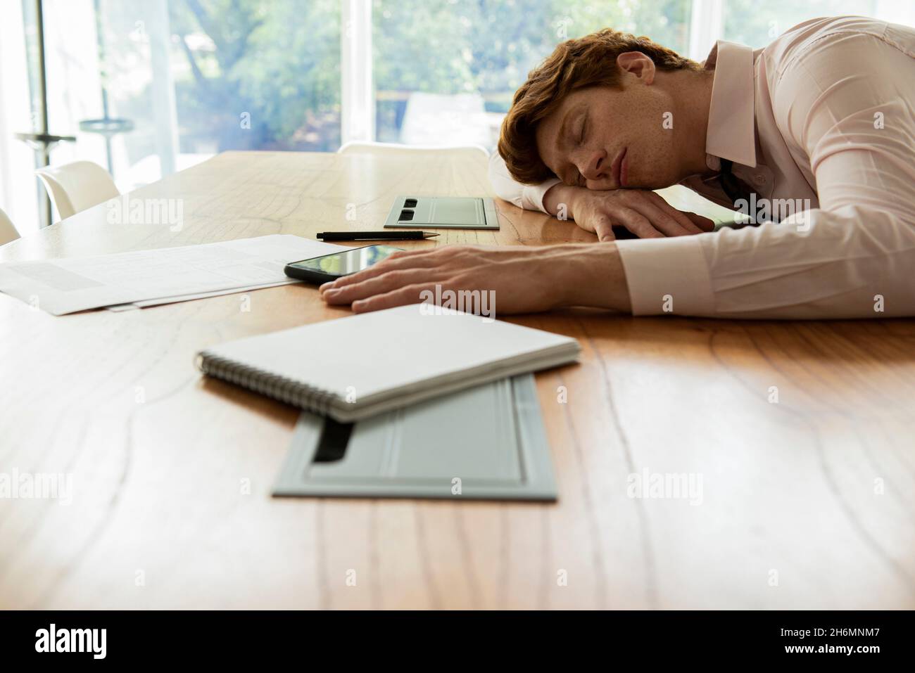 Tired businessman sleeping in office Stock Photo