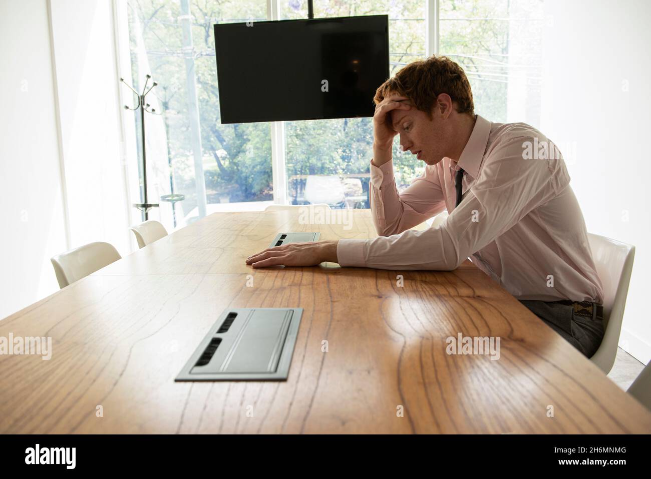 Tired businessman sitting in office Stock Photo