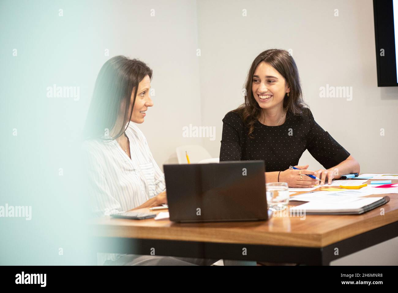Businesswomen talking with each other in office Stock Photo