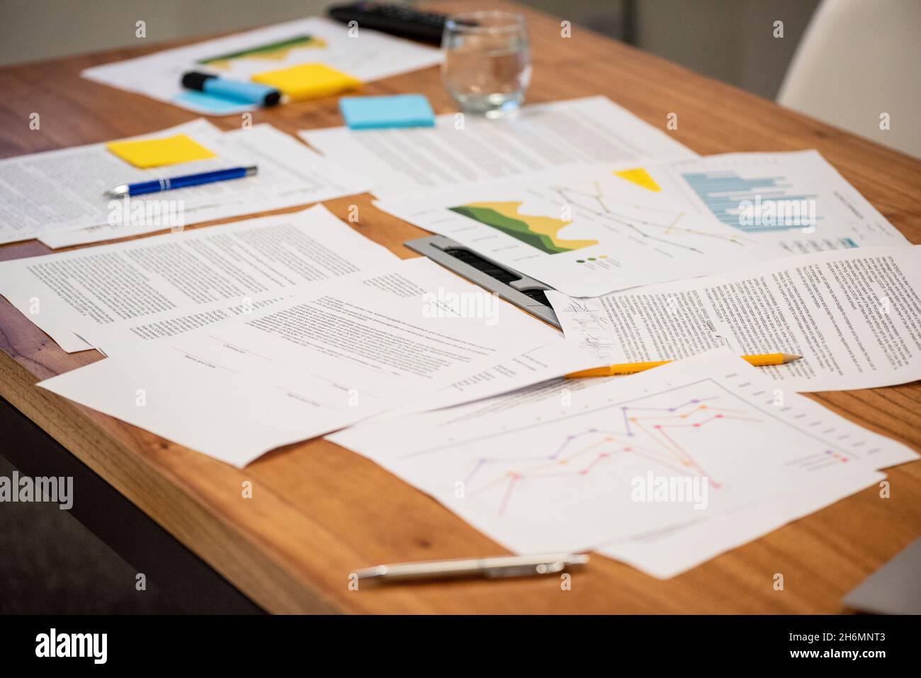 Close-up of documents and graph on table in office Stock Photo