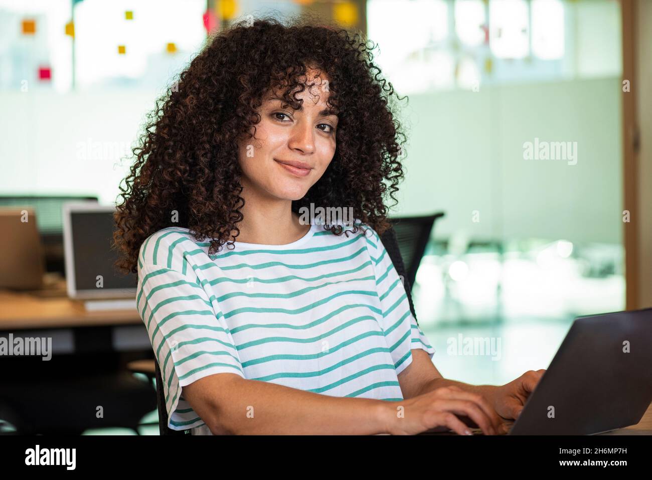 Businesswoman using laptop in office Stock Photo