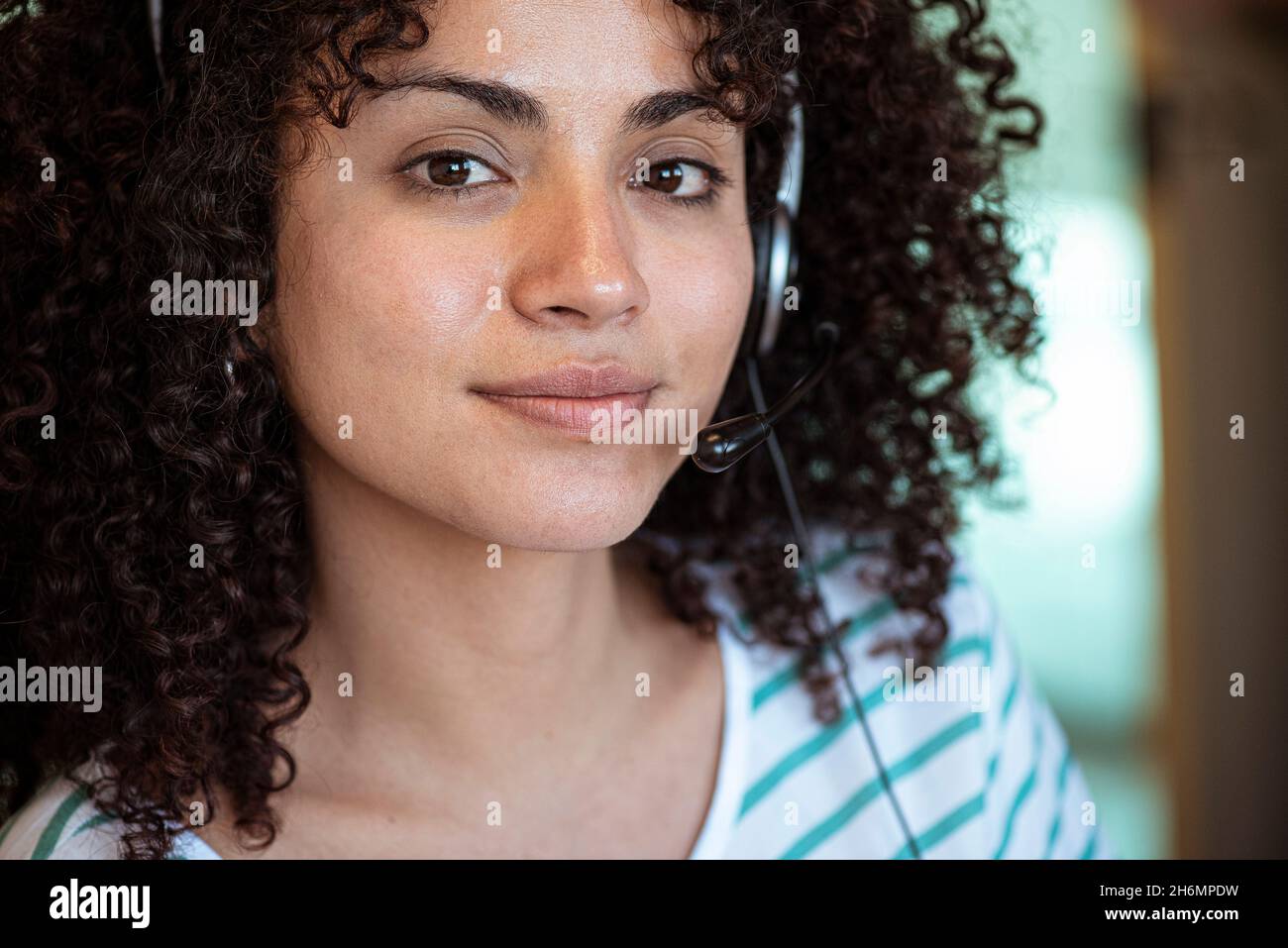 Close up of young woman wearing headset Stock Photo