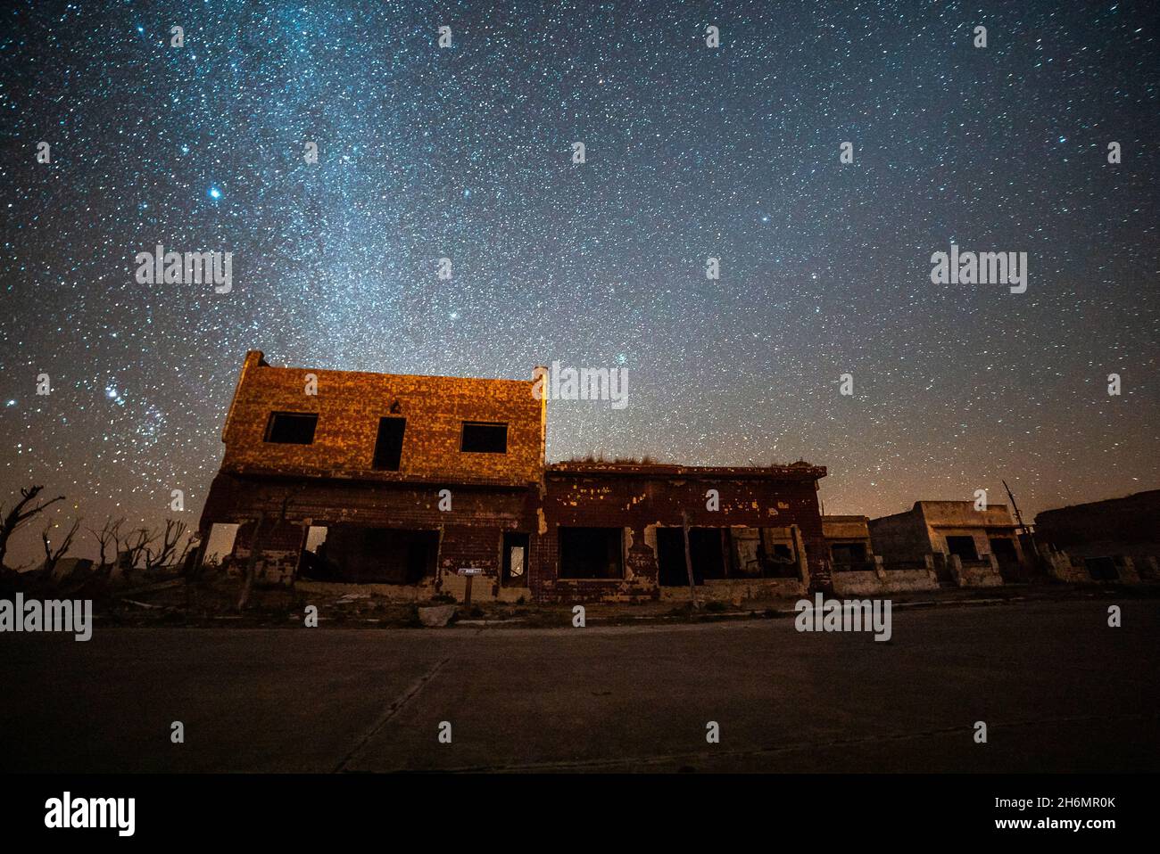 View of abandoned shops and houses against milky way in sky, Villa Epecuen Stock Photo