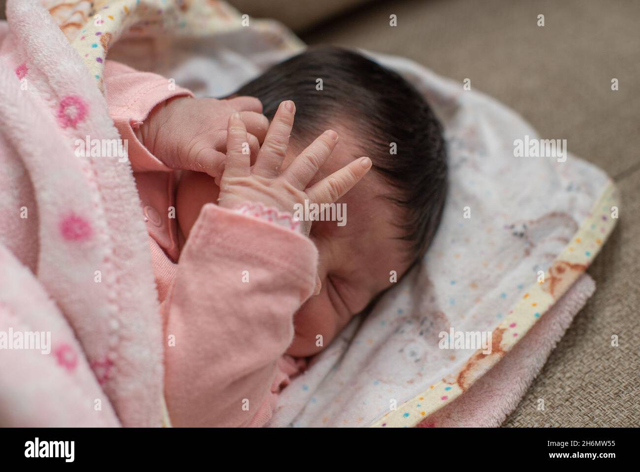 Cute Hispanic baby girl sleeping on a white and pink blanket Stock Photo Alamy