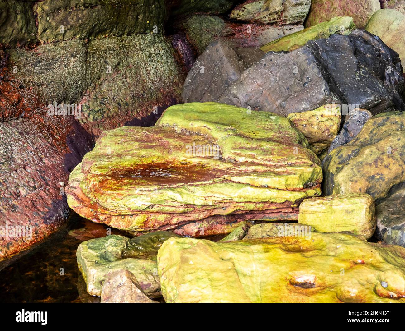 Colourful rocks in a small sea cave near Elgol on the Isle of Skye ...