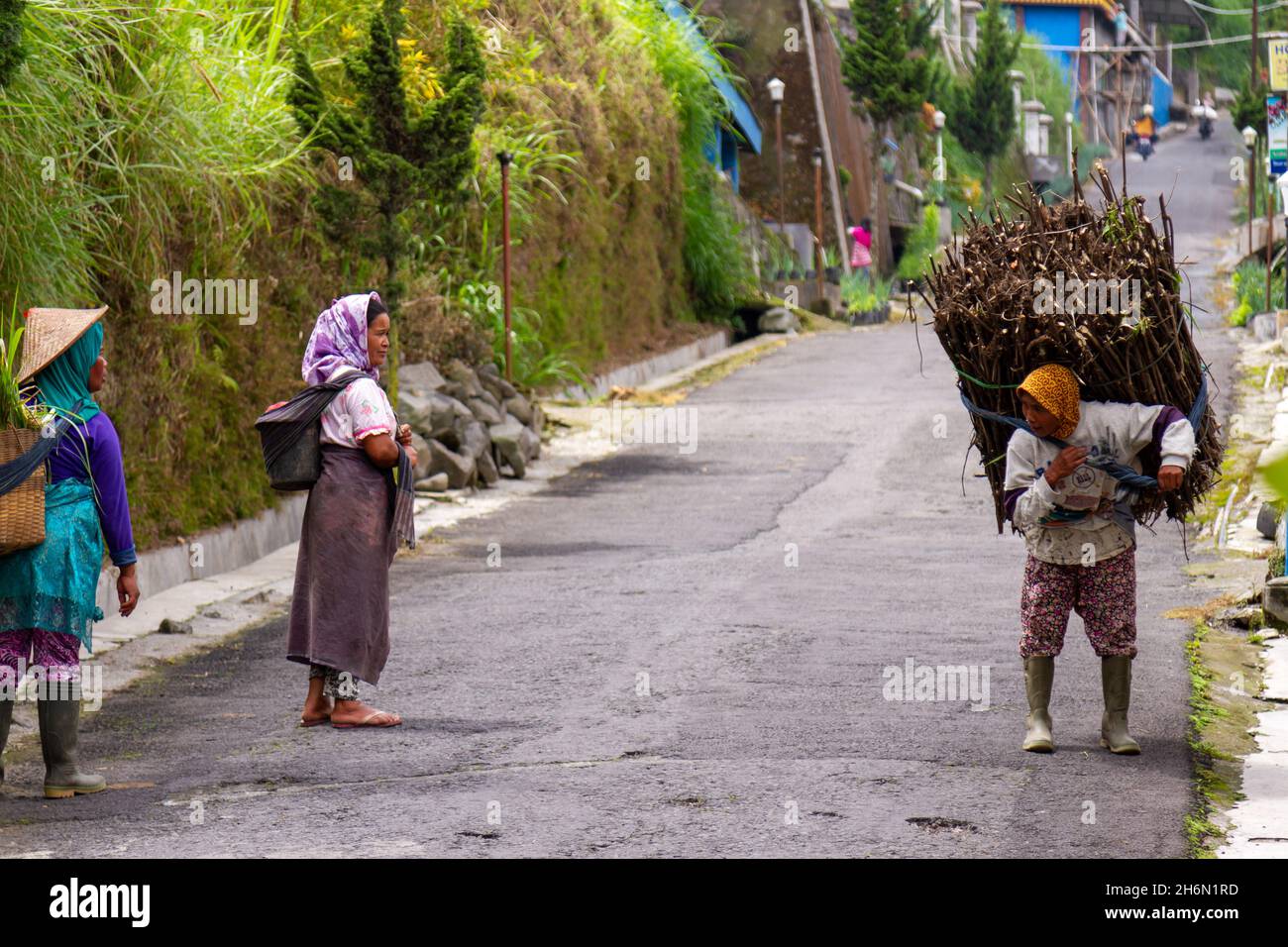 Local residents in the area of Mount Merapi carry out their usual ...