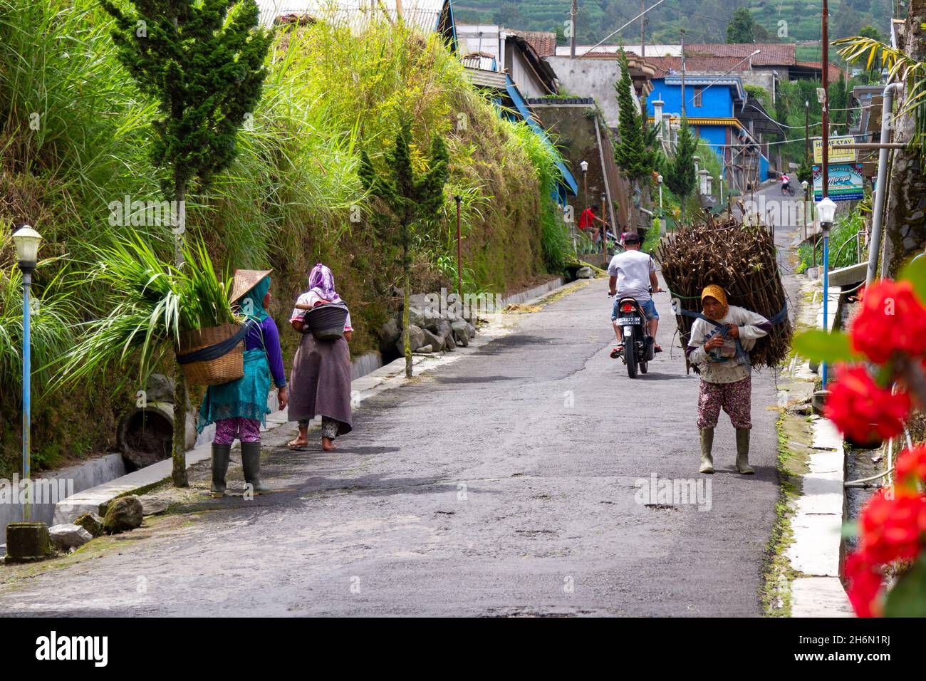Local residents in the area of Mount Merapi carry out their usual ...