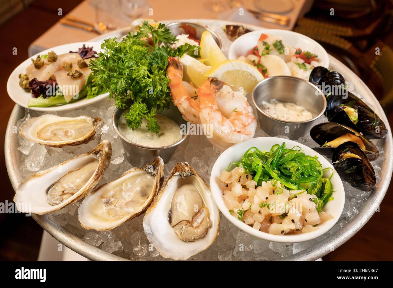 Chilled Seafood Platter, which includes local oysters, marinated mussels and clams, prawns, albacore tuna crudo, scallop ceviche, ahi tuna poke. Stock Photo
