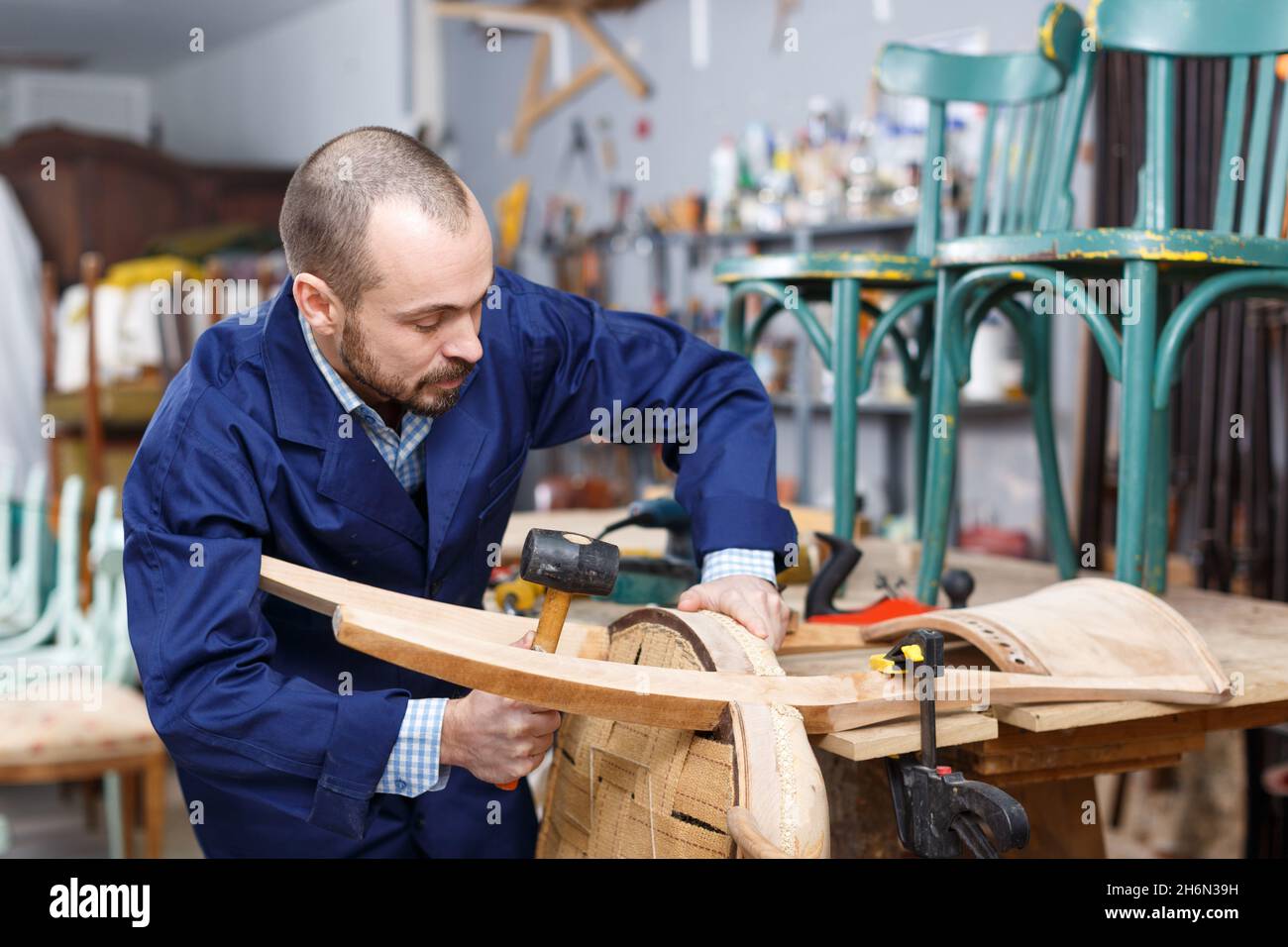 Craftsman repairing antique furniture Stock Photo Alamy