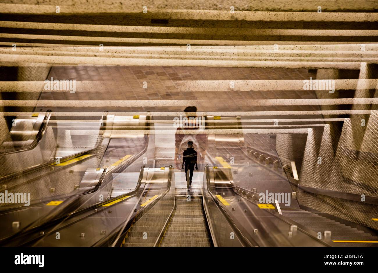 A man descends the escalators in a Montreal Metro station, Quebec, Canada Stock Photo