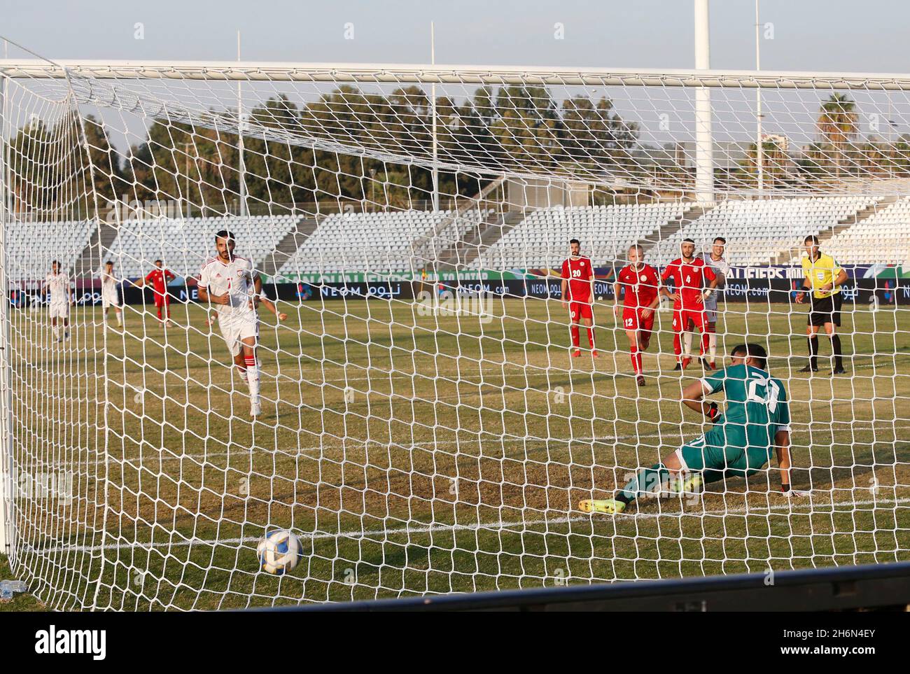 Beirut. 17th Nov, 2021. Ali Mabkhout (front 1st L) of the United Arab Emirates scores a penalty shot during the 2022 Qatar World Cup Asian Qualifiers football match between Lebanon and the United Arab Emirates at the Saida Stadium in the city of Sidon, southern Lebanon, on Nov. 16, 2021. Credit: Xinhua/Alamy Live News Stock Photo