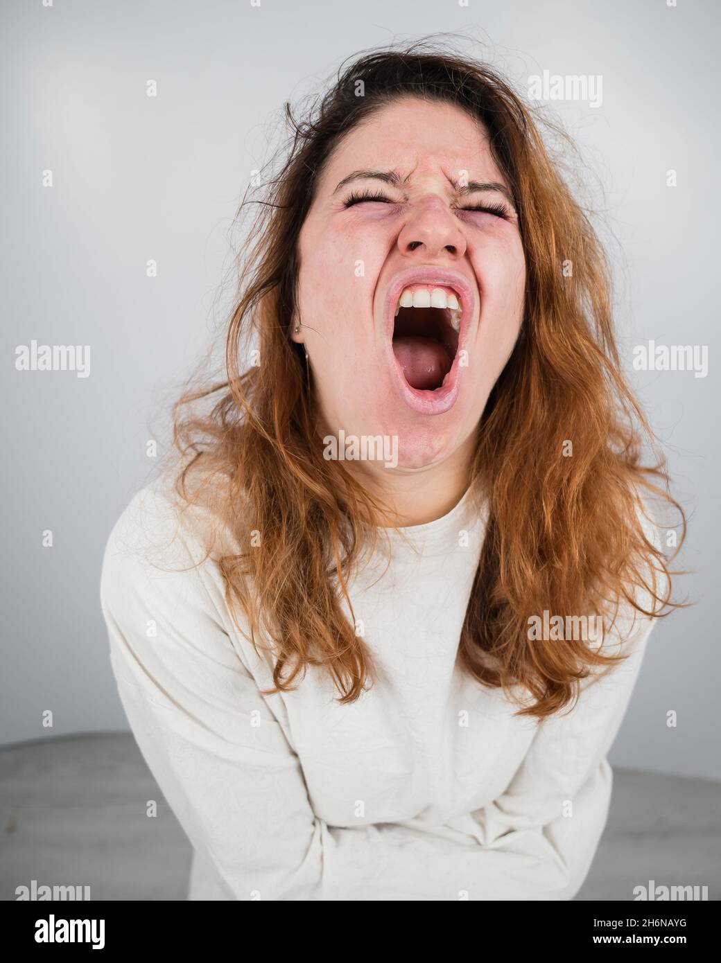 Close up portrait of insane woman in straitjacket on white background Close up portrait of insane woman in straitjacket on white background