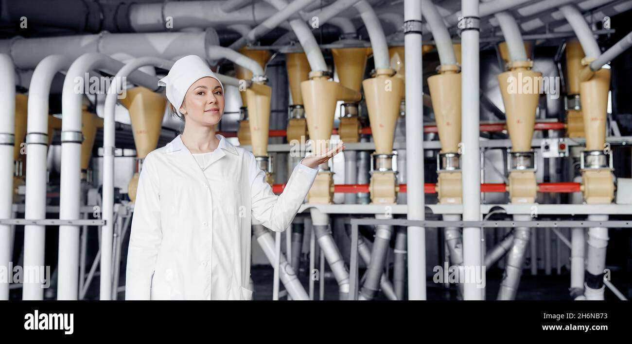 Banner Modern electrical mill machinery for production of wheat flour. Operator worker woman on