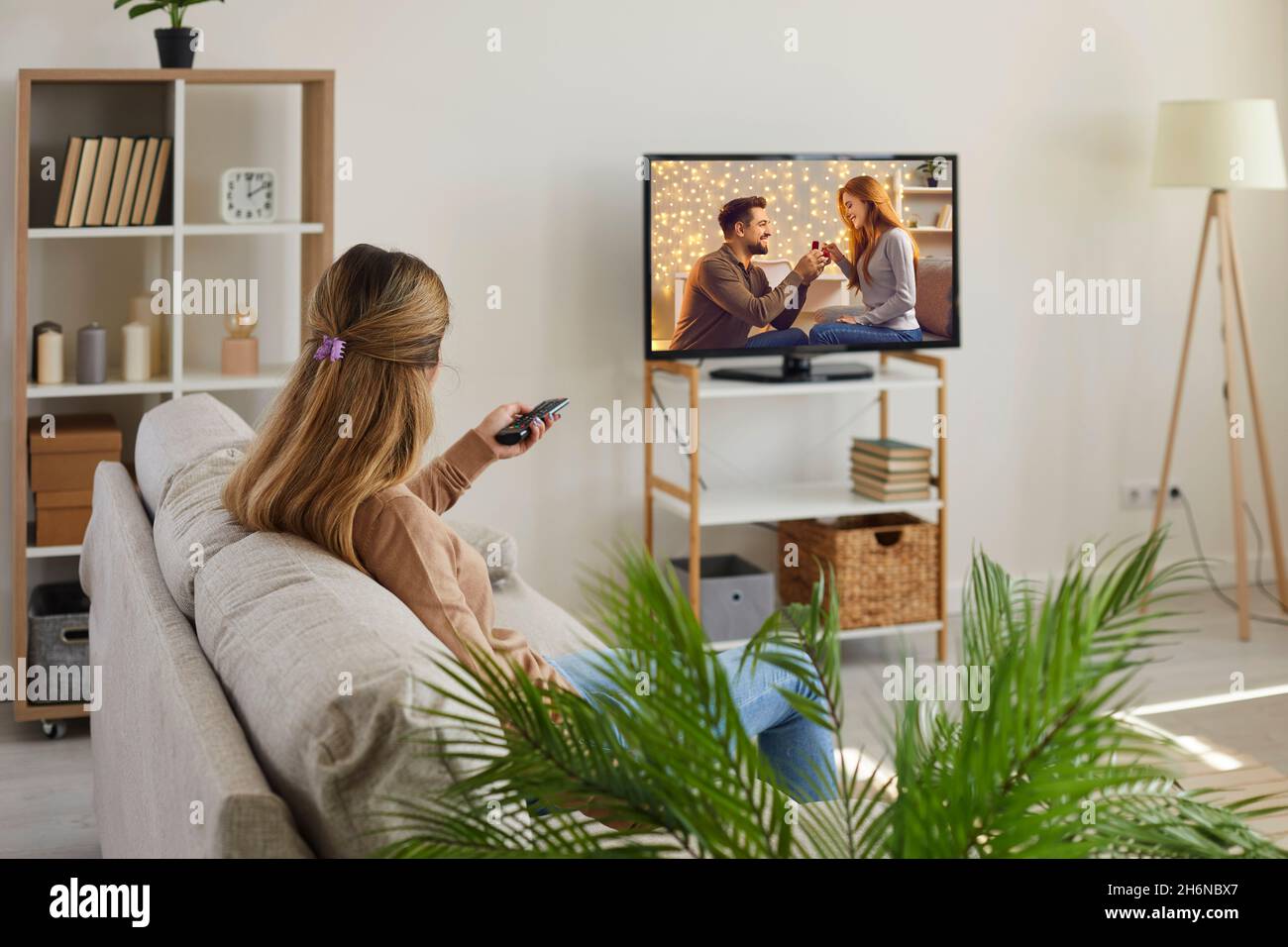 Young woman relax at home watching TV Stock Photo