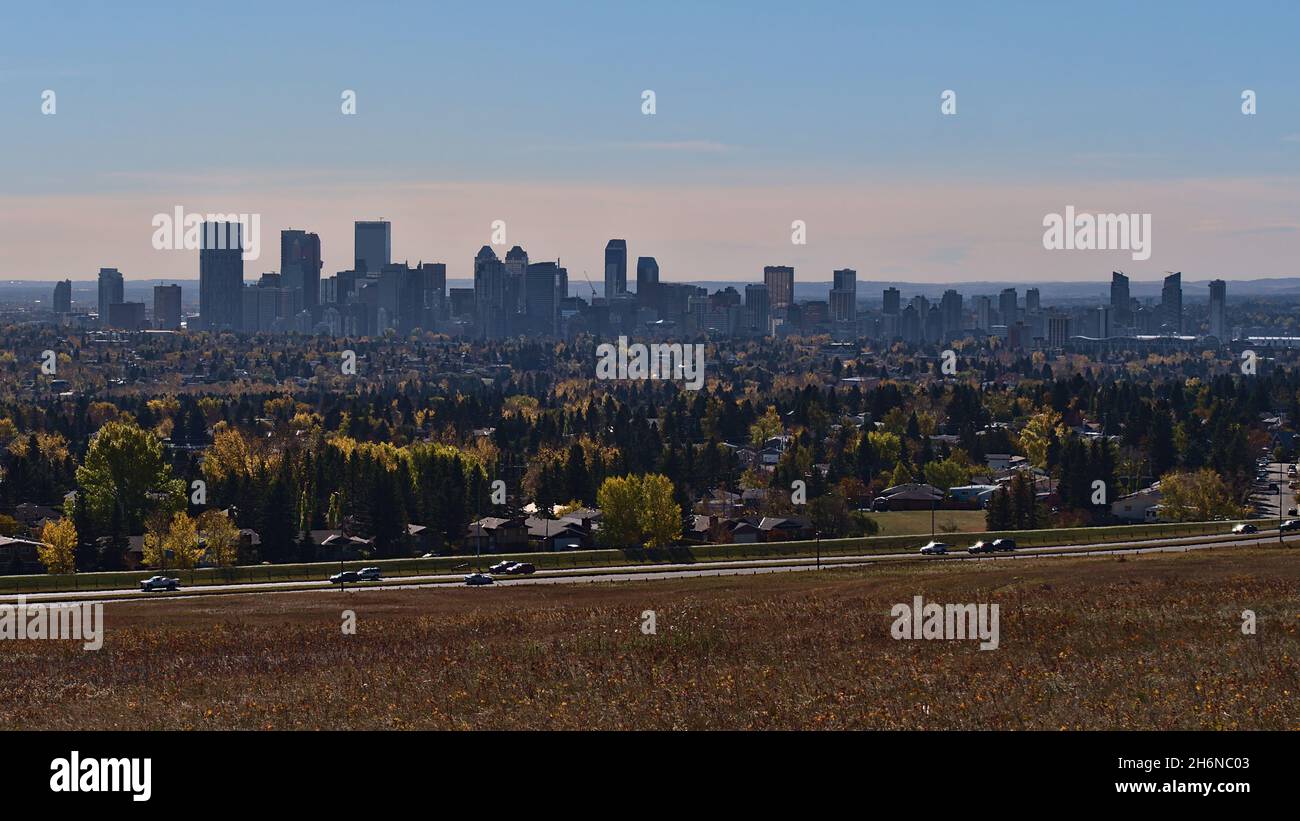 Beautiful cityscape of Calgary, Alberta, Canada in autumn season viewed from Nose Hill Park with colorful meadow, residential areas and skyline. Stock Photo