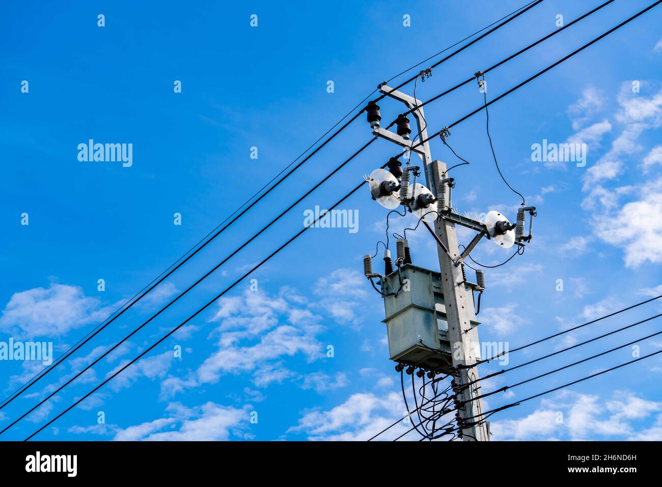 Electric pole and blue sky. Power and energy. Three-phase electric power for transfer power by electrical grids. Global energy crisis concept. Clean Stock Photo