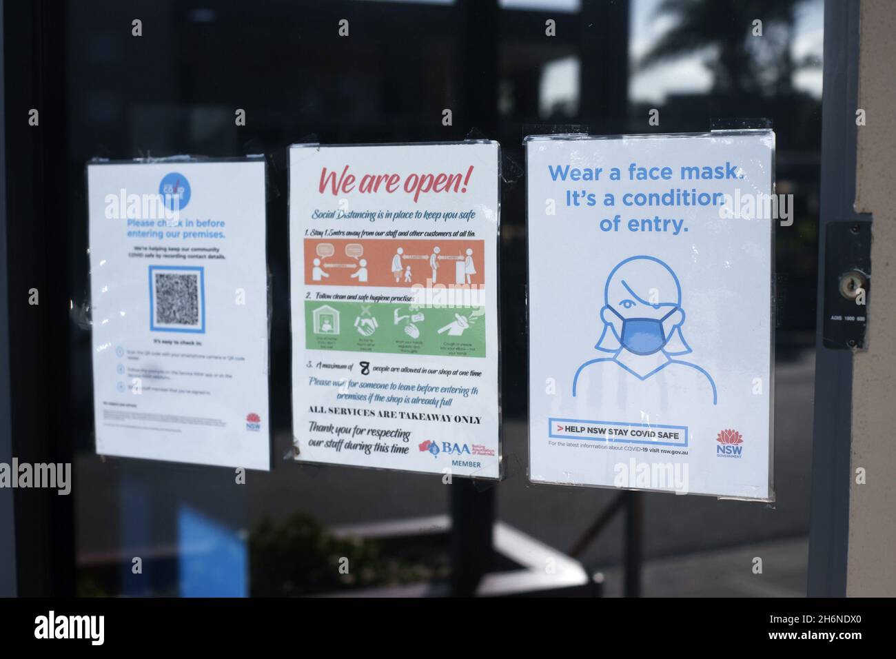 Australian Covid-19 signage with QR code and sign requesting that face masks be worn inside the commercial premises. Stock Photo
