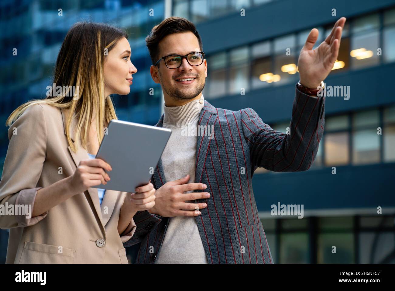 Portrait of successful business people working, talking together in urban background. Stock Photo