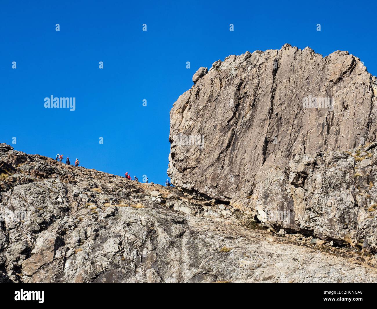 Climbers below the Inaccessible Pinnacle on Sgurr Dearg on the Cuillin Ridge on the Isle of Skye, Scotland, UK. The In Pin is the hardest of all Scotl Stock Photo