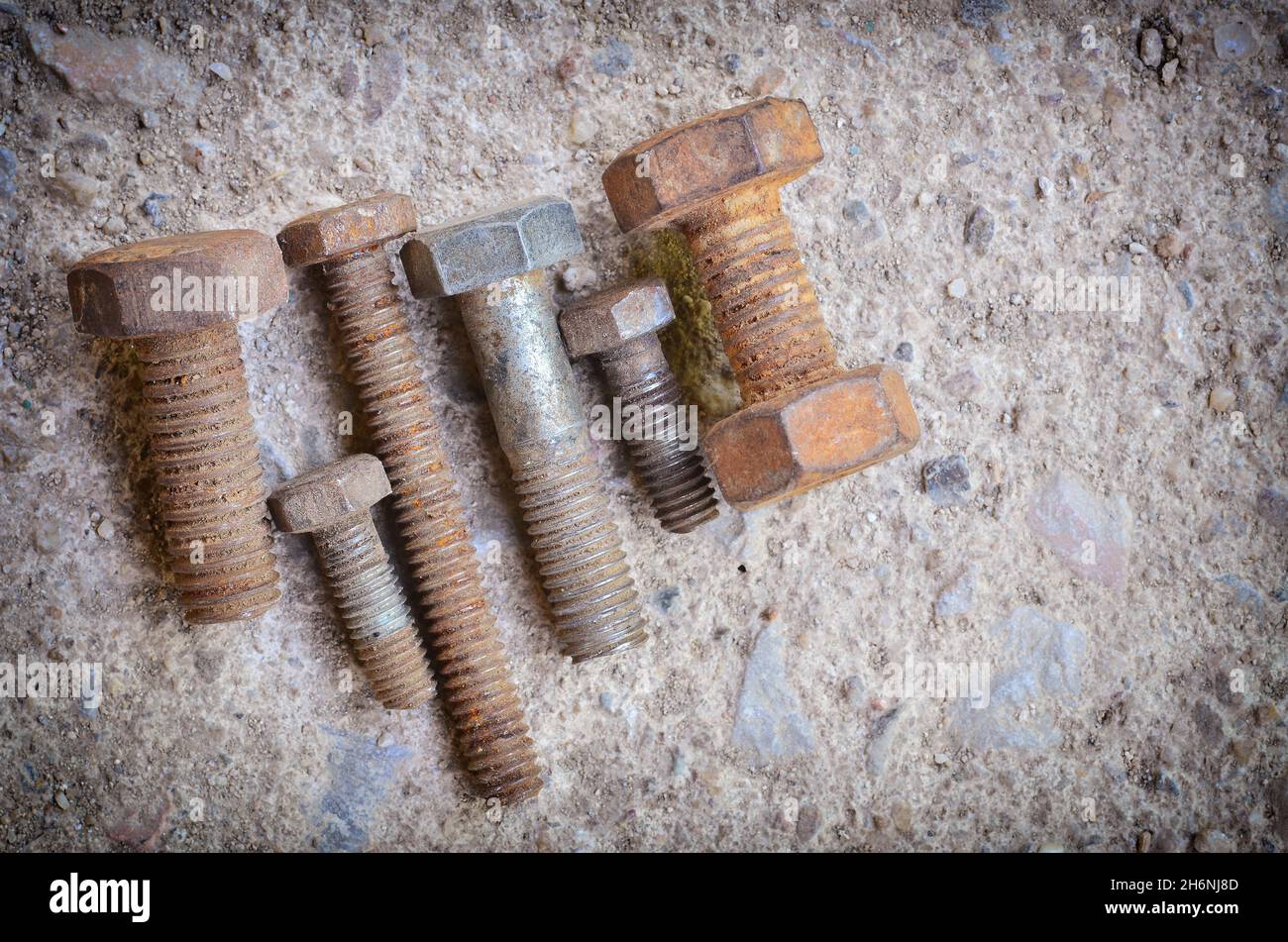 Many old nut on concrete Stock Photo
