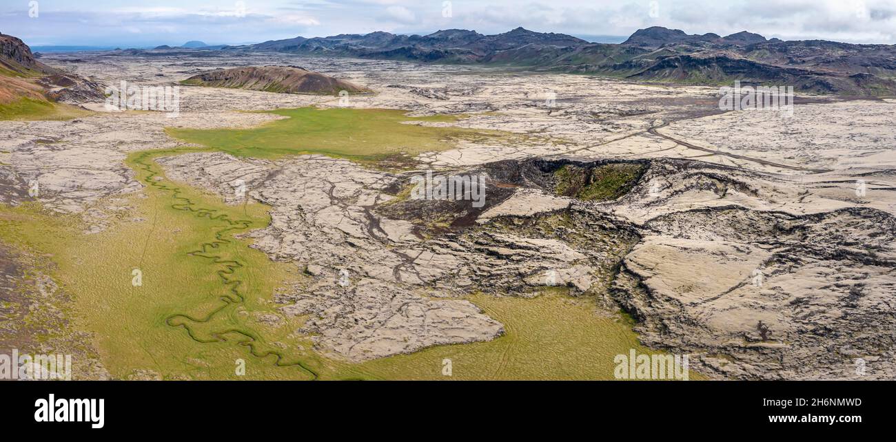 Volcanic crater, moss-covered landscape with river, Icelandic highlands ...