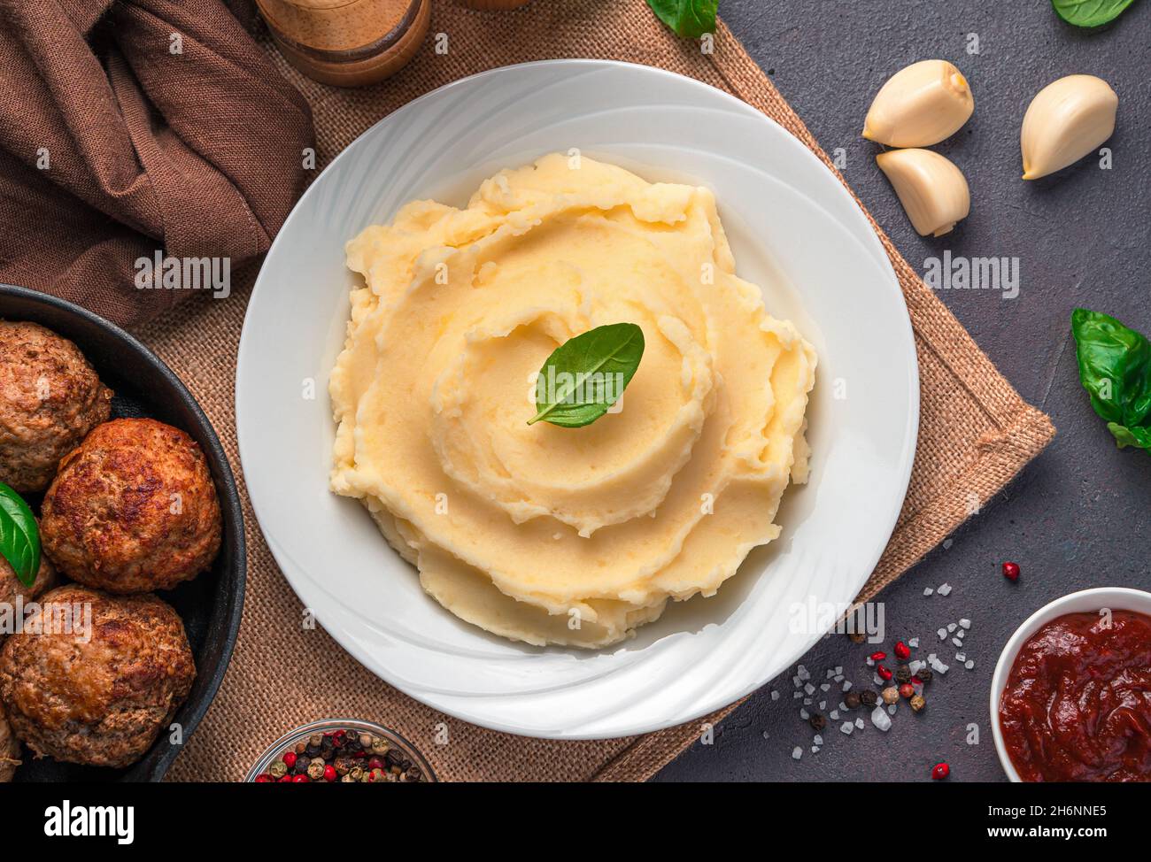 Lunch with mashed potatoes on a dark background. Top view, close-up. Stock Photo