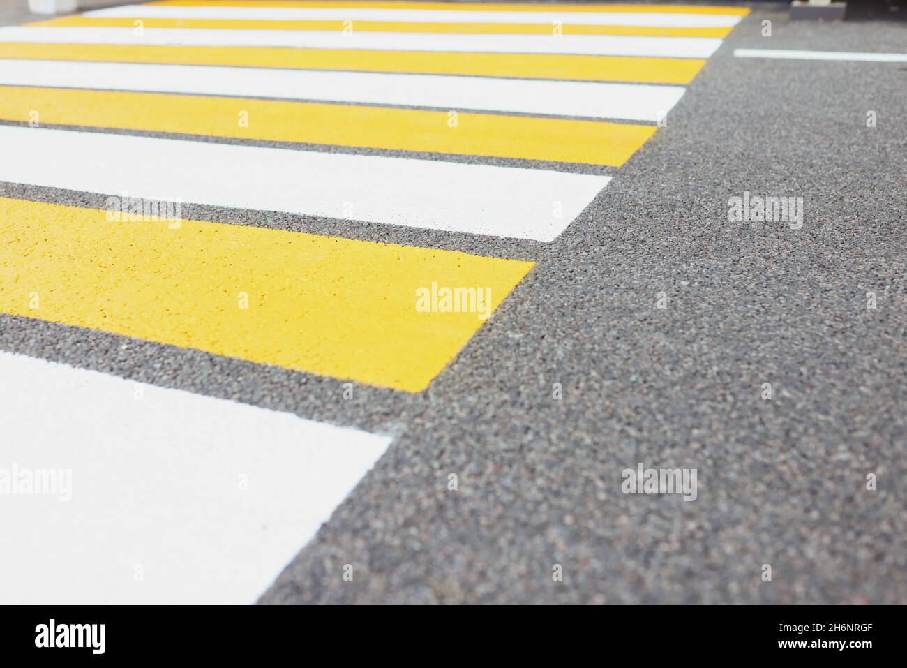 Marked white and yellow walkway across road or street Stock Photo