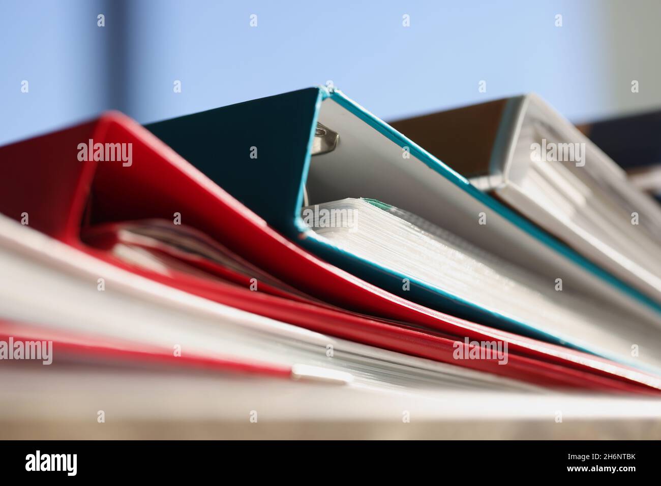 Stack of colourful folders for documents on table Stock Photo