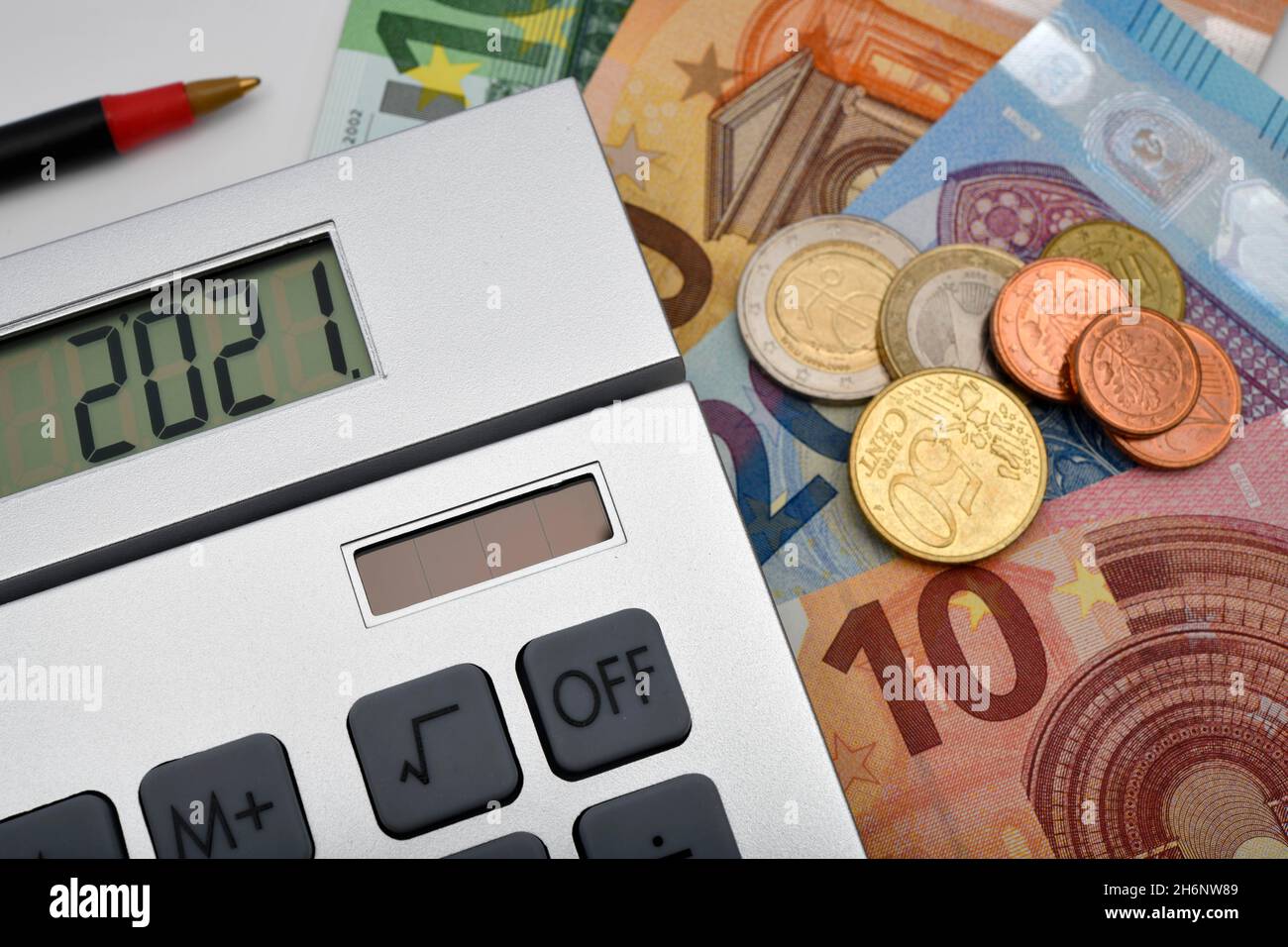 Symbol image Costs 2021, calculator, EURO banknotes and coins, red pencil, Baden-Wuerttemberg, Germany Stock Photo