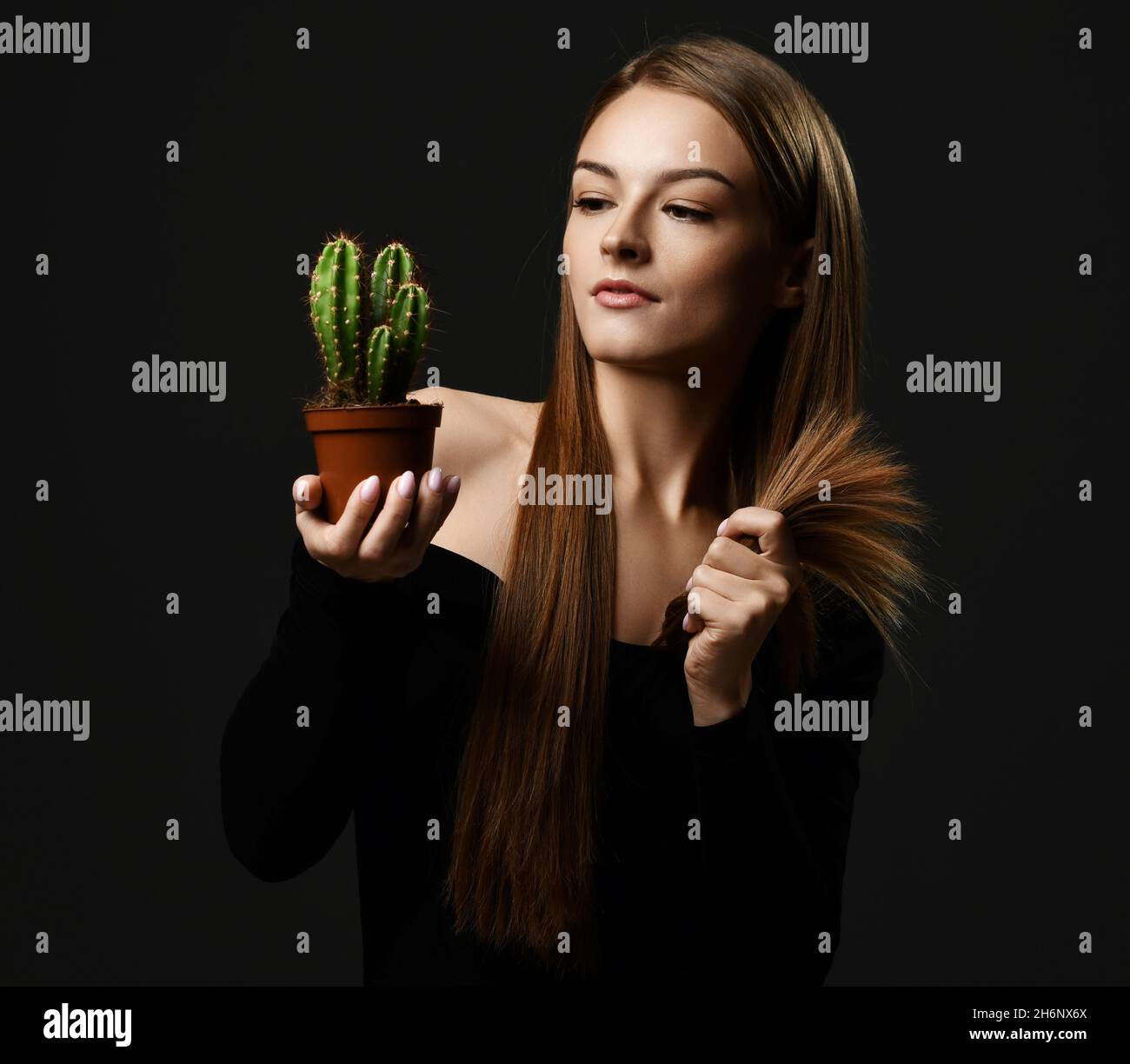 Young beautiful woman with long silky straight hair in black body