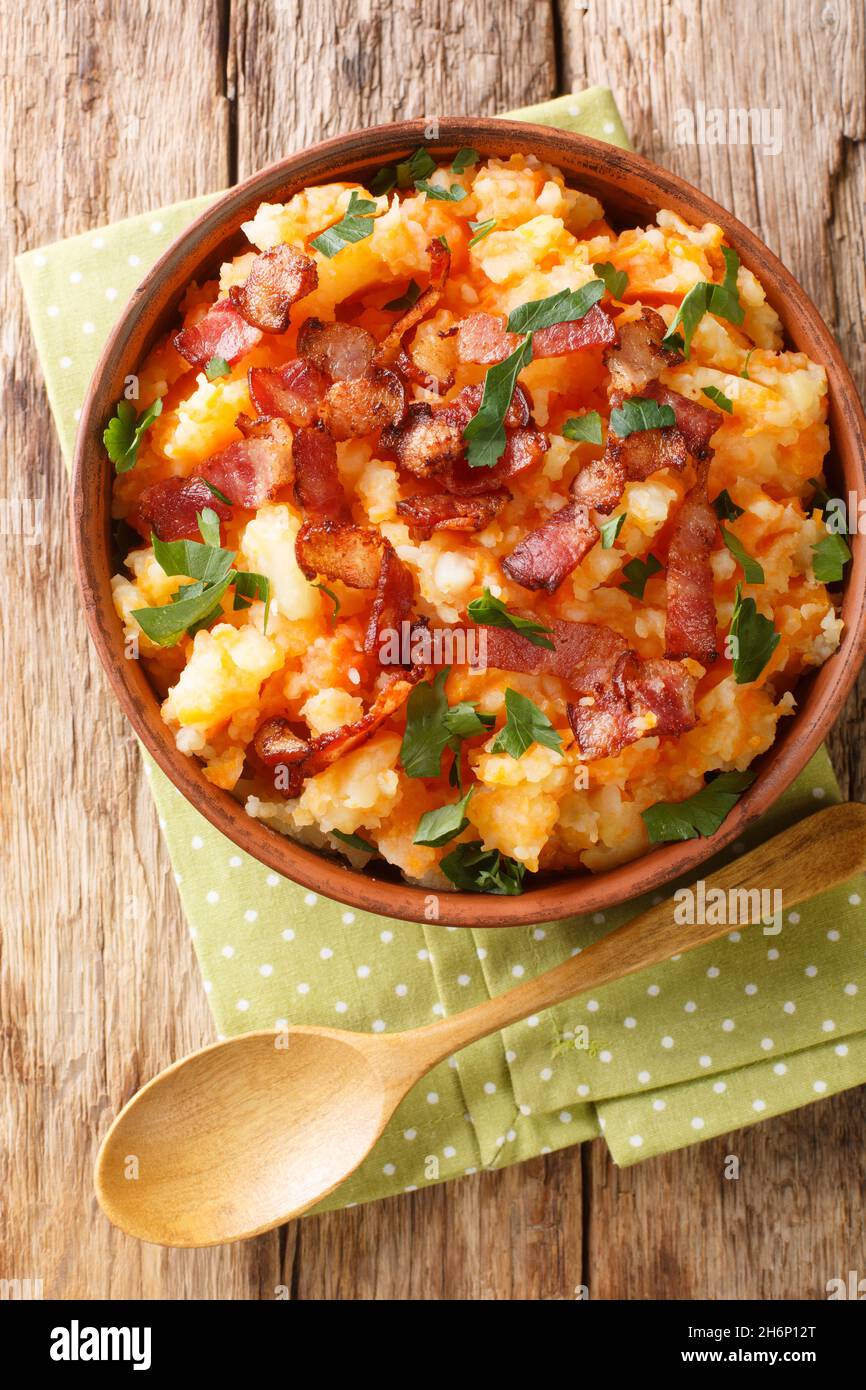 Hutspot Dutch, hochepot French or hotchpotch English, is a dish of boiled  and mashed potatoes, carrots and onions close up in the bowl on the table.  V Stock Photo - Alamy