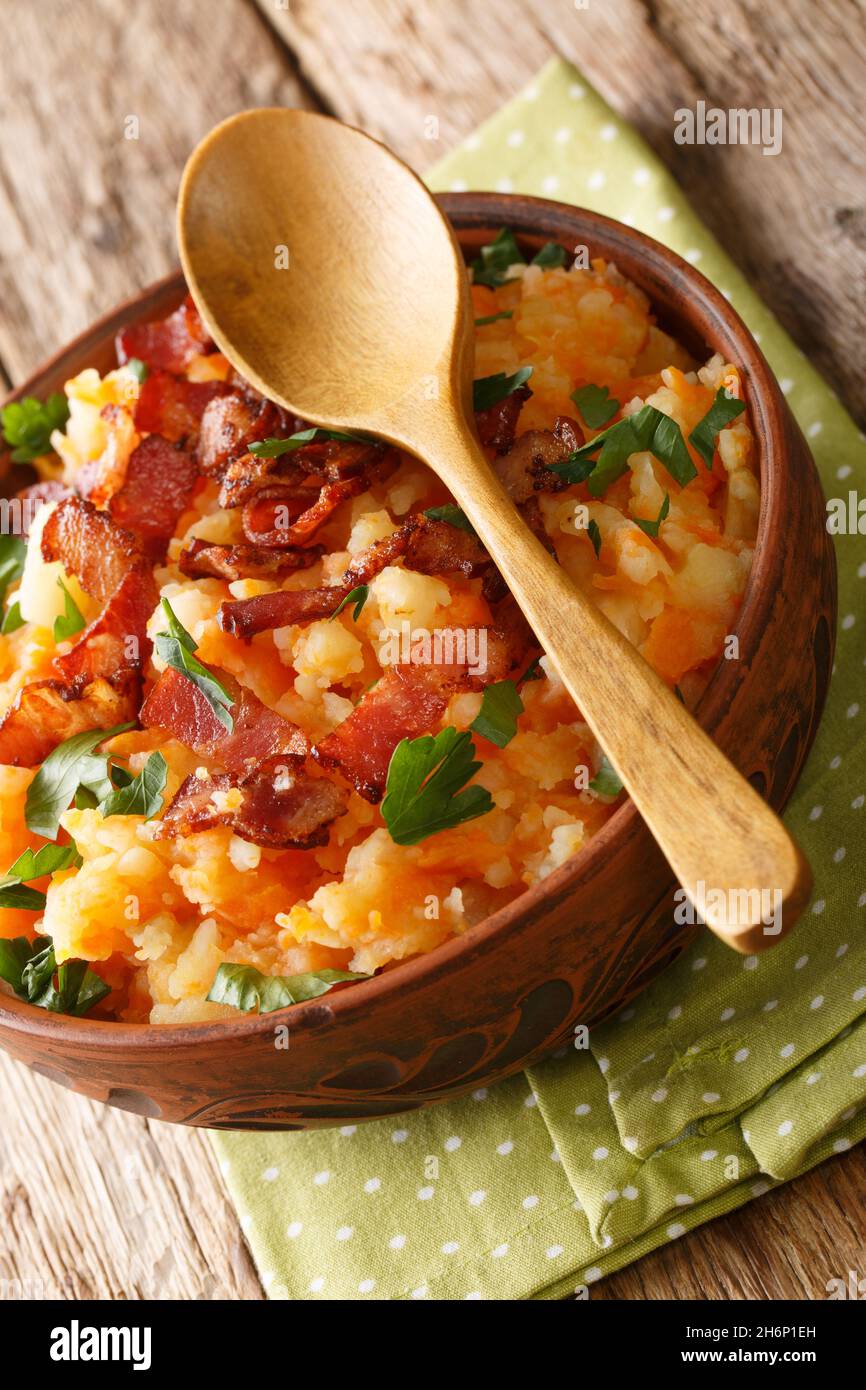 Hutspot Dutch, hochepot French or hotchpotch English, is a dish of boiled  and mashed potatoes, carrots and onions close up in the bowl on the table.  V Stock Photo - Alamy