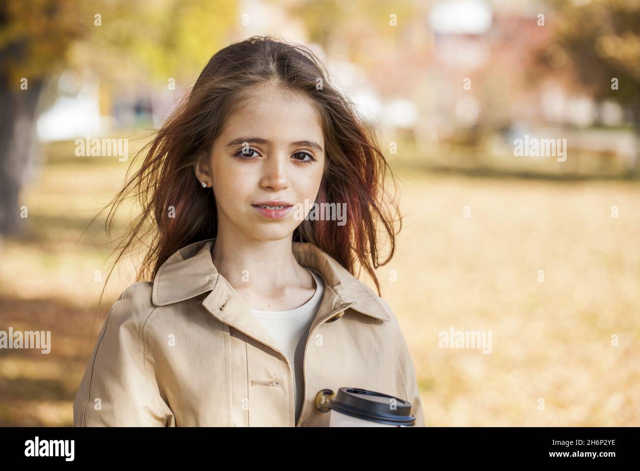 Portrait of a young girl in an autumn park Stock Photo - Alamy