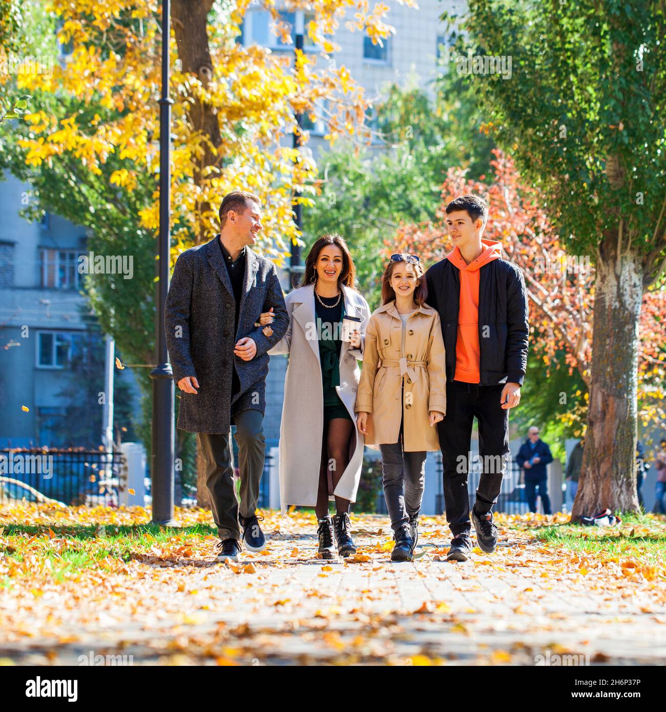 Happy family walking in the autumn park Stock Photo - Alamy